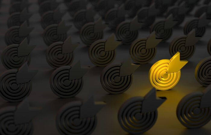 The Gold Target Symbol between the Target Symbols in the dark. Standing Out From The Crowd Concept.
